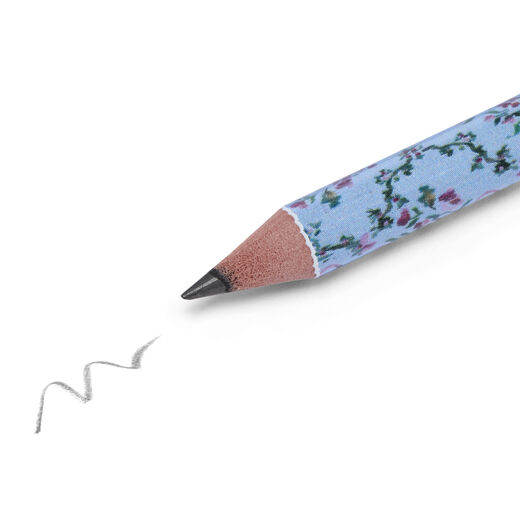 A close up of the tip of the pencil, with a scribble on white paper.